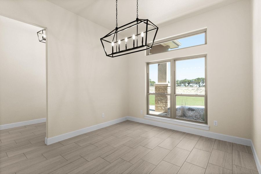 Unfurnished dining area featuring a chandelier and wood finish floors Unfurnished dining area featuring a chandelier and wood finish floors