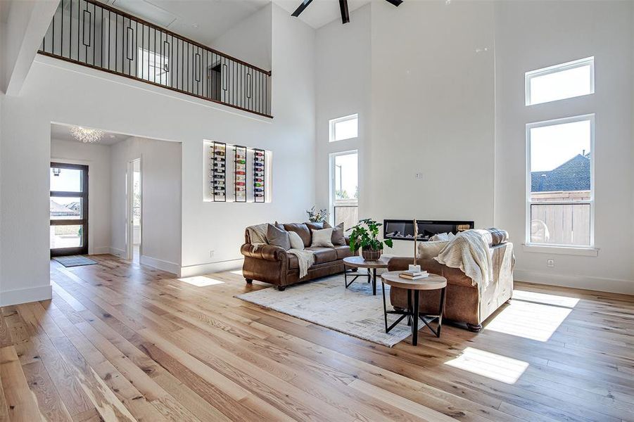 The entry way. Living area featuring light wood-style flooring, healthy amount of natural light, and a high ceiling. The entry way. Living area featuring light wood-style flooring, healthy amount of natural light, and a high ceiling.