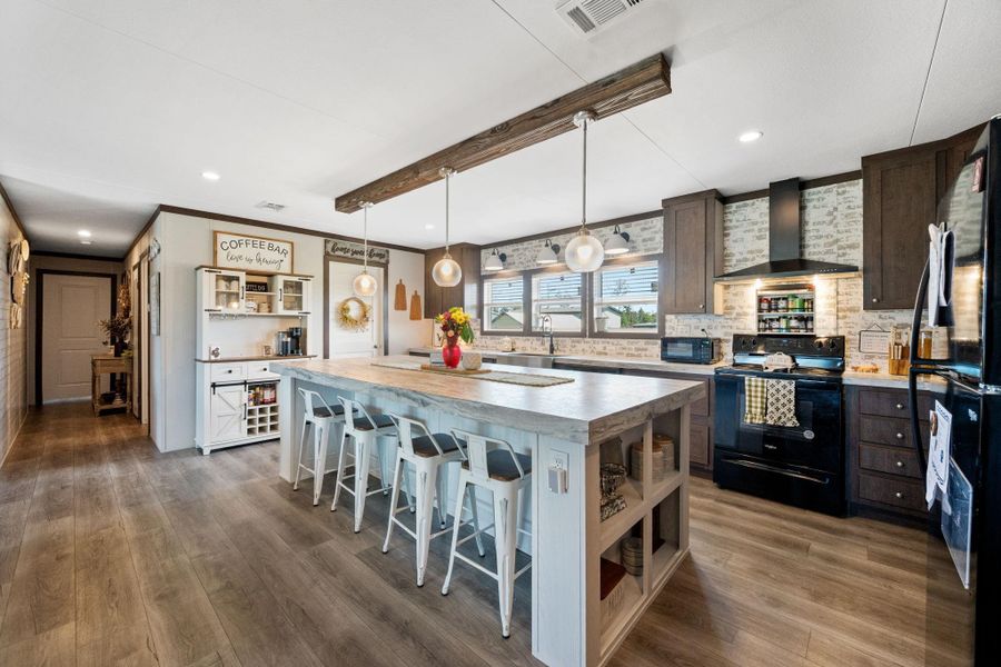 Kitchen has large family island and plenty of cabinets and a pantry.