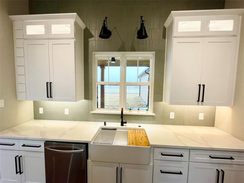 Quartz countertops, large farm sink and view of cows.