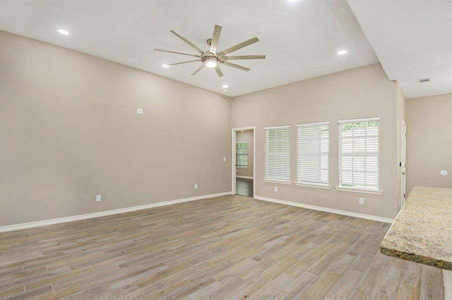 Unfurnished living room featuring ceiling fan, light wood finished floors, and recessed lighting