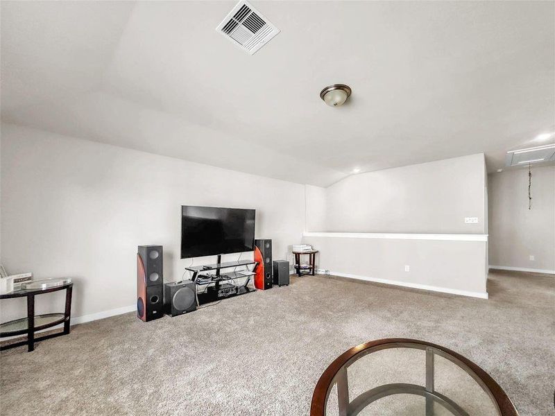 Spacious and light-filled living room featuring an open-concept layout, high ceilings, and seamless flow into the kitchen and dining areas—perfect for everyday living and entertaining.
