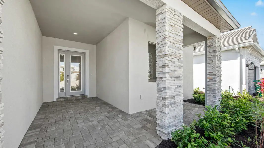 Exterior details and patio area of a home in SkySail Real Estate and Homes for Sale in Naples, FL - Neal Communities, Naples (Image 3).