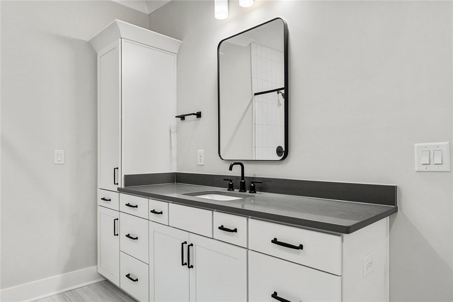 A well-appointed primary bathroom features a conte A well-appointed primary bathroom features a conte