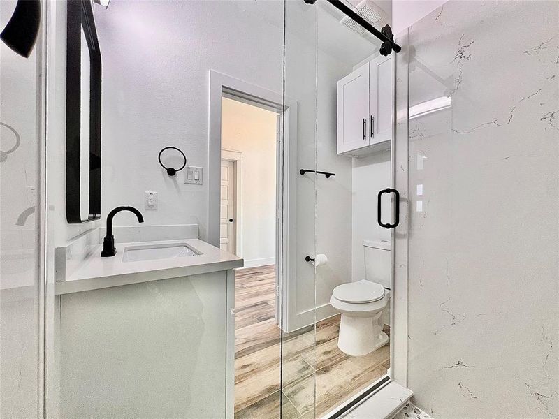 3rd. Full Bathroom, Beautiful Glass Doors, plus Upper Cabinet above Commode for extra Storage.