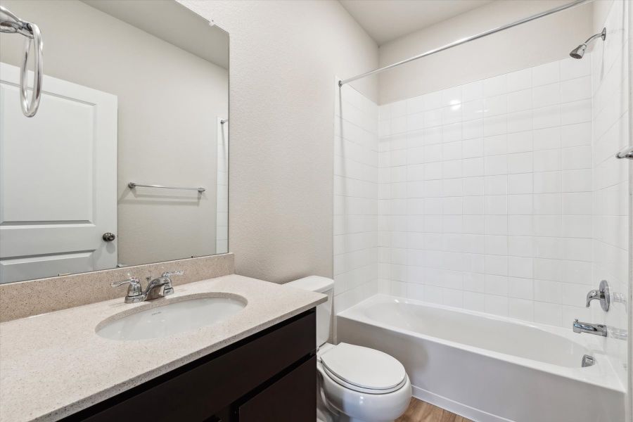 A bathroom with a sink toilet and bathtub.