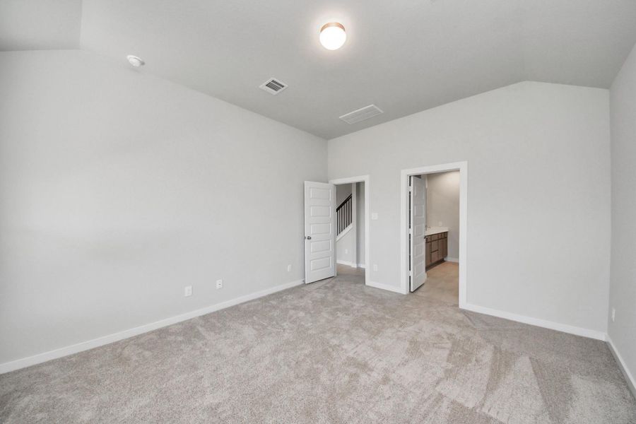 Come and unwind after a long day in this magnificent primary suite! This spacious room features plush carpet, warm paint, high ceilings and large windows with privacy blinds. Sample photo of completed home with similar floor plan. Actual colors and selections may vary.