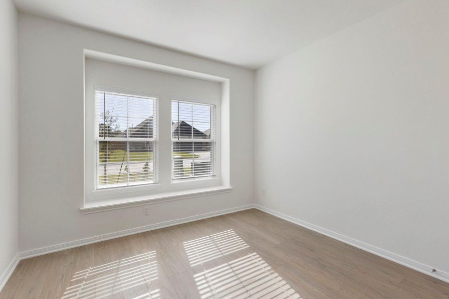 Secondary Bedroom #1 includes a bright, inviting space with a large window and a charming ledge.