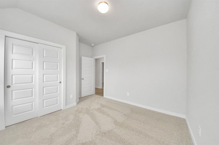 Generously sized secondary bedrooms featuring spacious closets, soft and inviting carpeting underfoot, large windows allowing plenty of natural light, and the added touch of privacy blinds for your personal retreat.