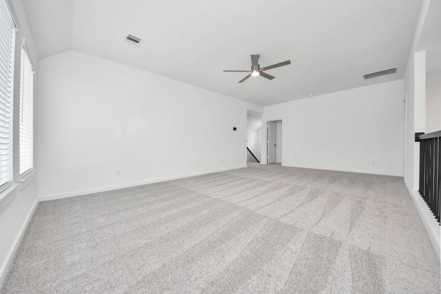 Come upstairs and enjoy a day of leisure in this fabulous game room! This is the perfect hangout spot or adult game room! Features plush carpet, high ceilings, custom paint and windows for plenty of natural light. Sample photo of completed home with similar floor plan. Actual colors and selections may vary. Come upstairs and enjoy a day of leisure in this fabulous game room! This is the perfect hangout spot or adult game room! Features plush carpet, high ceilings, custom paint and windows for plenty of natural light. Sample photo of completed home with similar floor plan. Actual colors and selections may vary.