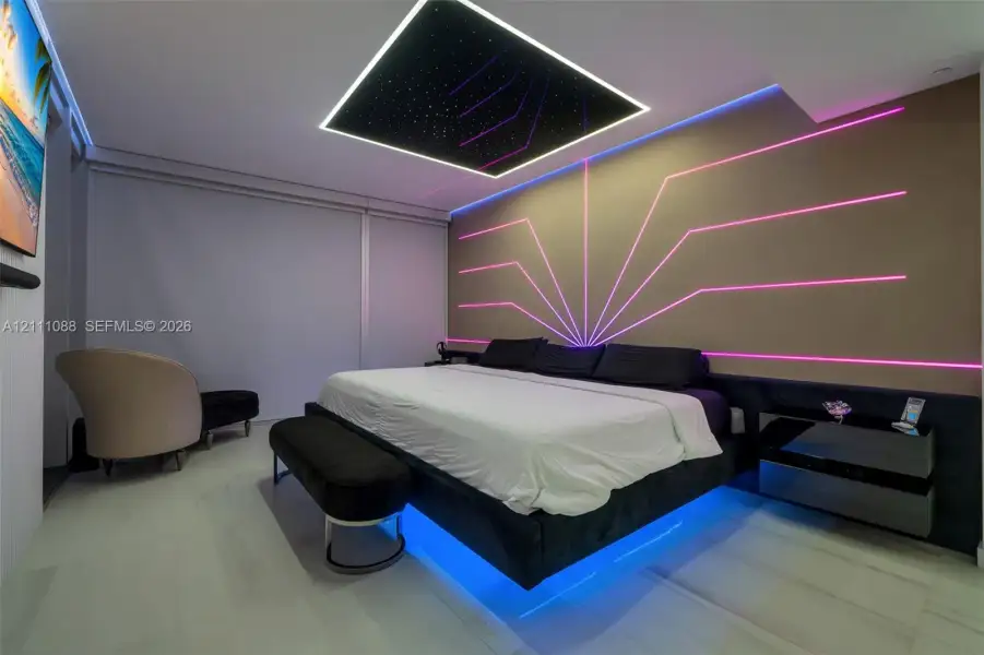 Tray ceiling featuring integrated fiber-optic lighting, wall-mounted linear accent lighting, and large-format tile flooring Tray ceiling featuring integrated fiber-optic lighting, wall-mounted linear accent lighting, and large-format tile flooring