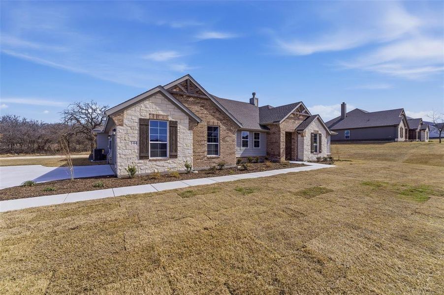 Front exterior of a new home in Oak Grove Addition, Springtown, TX, highlighting curb appeal (Image 16).