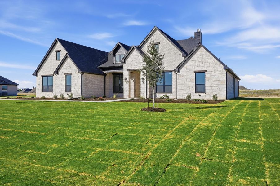 Front exterior of a new home in Rocky Top Ranch, Azle, TX, highlighting curb appeal (Image 2). Front exterior of a new home in Rocky Top Ranch, Azle, TX, highlighting curb appeal (Image 2).