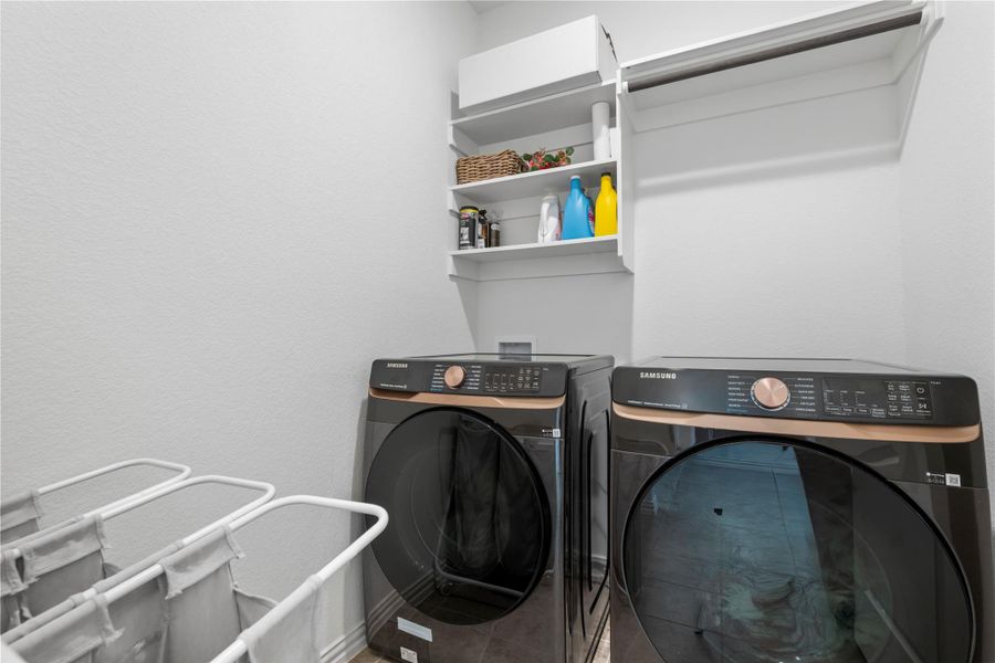 A dedicated laundry room features modern appliances and practical shelving for organization. A dedicated laundry room features modern appliances and practical shelving for organization.