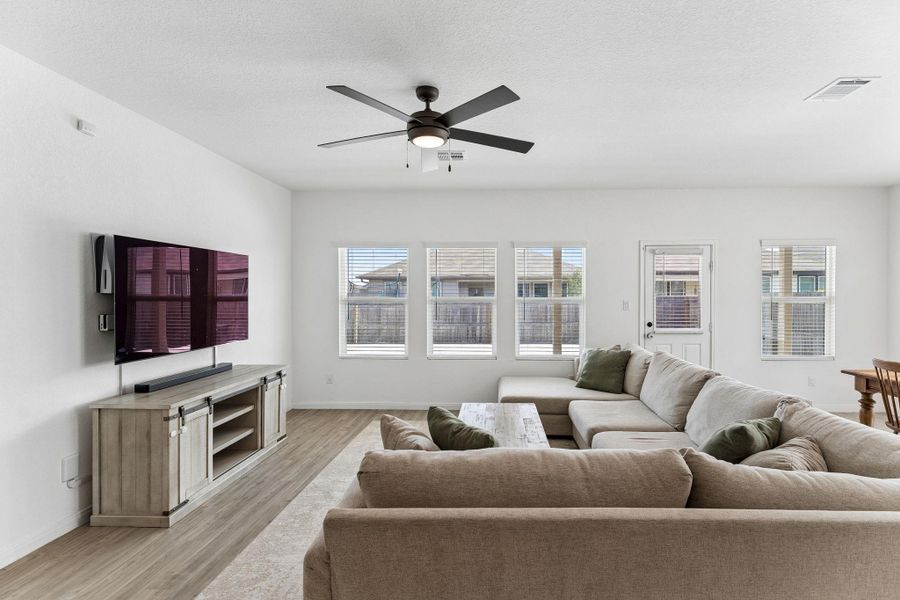 A well-lit living area offers contemporary flooring and ample natural illumination.