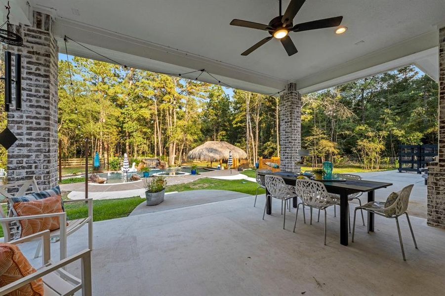 Step outside on this 265 sq./ft. covered patio set high above the $231,000 fantastic outdoor retreat, featuring a beautiful pool, relaxing hot tub, beach entry, sun shelves, a swim up bar for 5, and massive tiki bar providing shade on the hot days and cover from the rain.