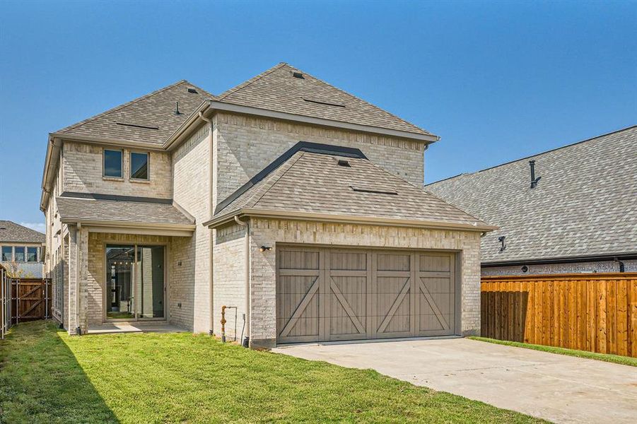 View of front of property with a garage and a front yard