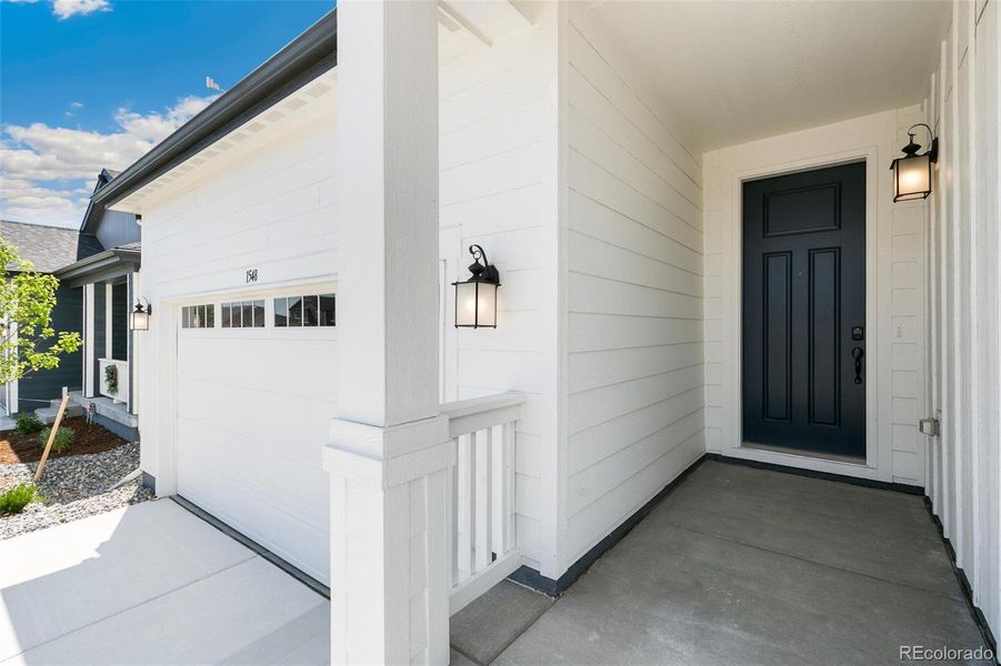 Front exterior of a new home in Farmlore, Brighton, CO, highlighting curb appeal (Image 19).