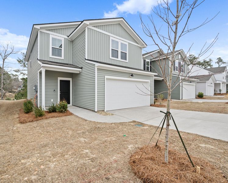 Front exterior of a new home in Grand Arbor, Blythewood, SC, highlighting curb appeal (Image 1). Front exterior of a new home in Grand Arbor, Blythewood, SC, highlighting curb appeal (Image 1).