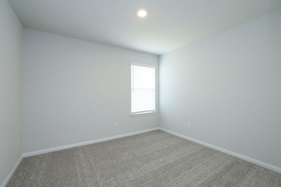 Bedroom #3 features carpet in a neutral tone and ceiling light. Ideal for a bedroom or office space.