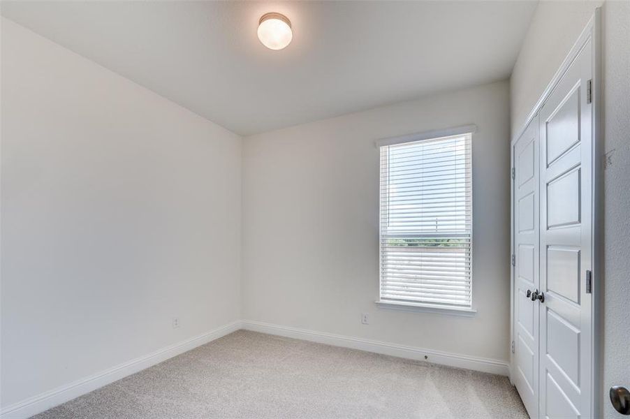 Unfurnished room with light carpet and baseboards