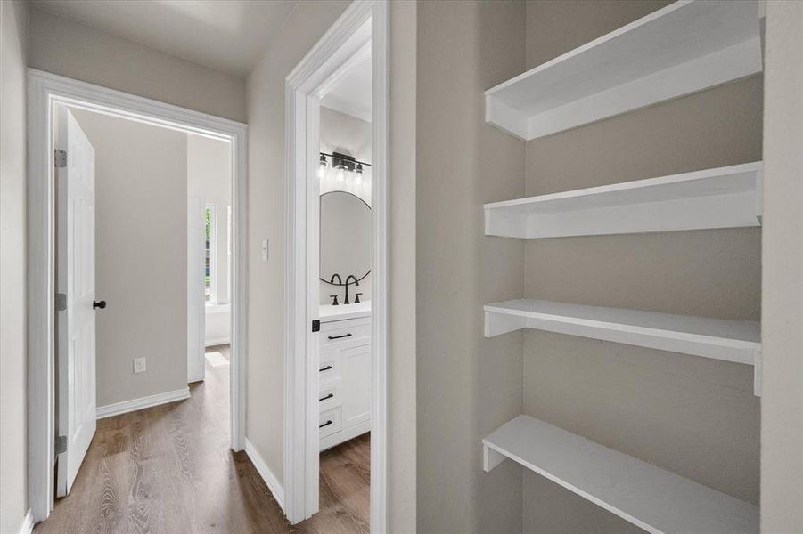 Built-in shelving unit with multiple white shelves