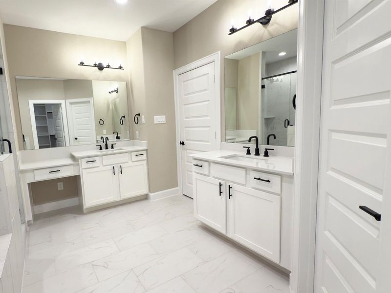The ROCburne primary bath offers a spa-like retreat with a deep soaking tub and a sleek, glass-enclosed shower, blending relaxation and modern style. Image depicts home as-is. The ROCburne primary bath offers a spa-like retreat with a deep soaking tub and a sleek, glass-enclosed shower, blending relaxation and modern style. Image depicts home as-is.