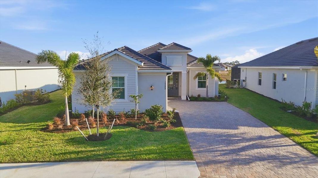 Front exterior of a new home in Heritage Landing, Punta Gorda, FL, highlighting curb appeal (Image 2).