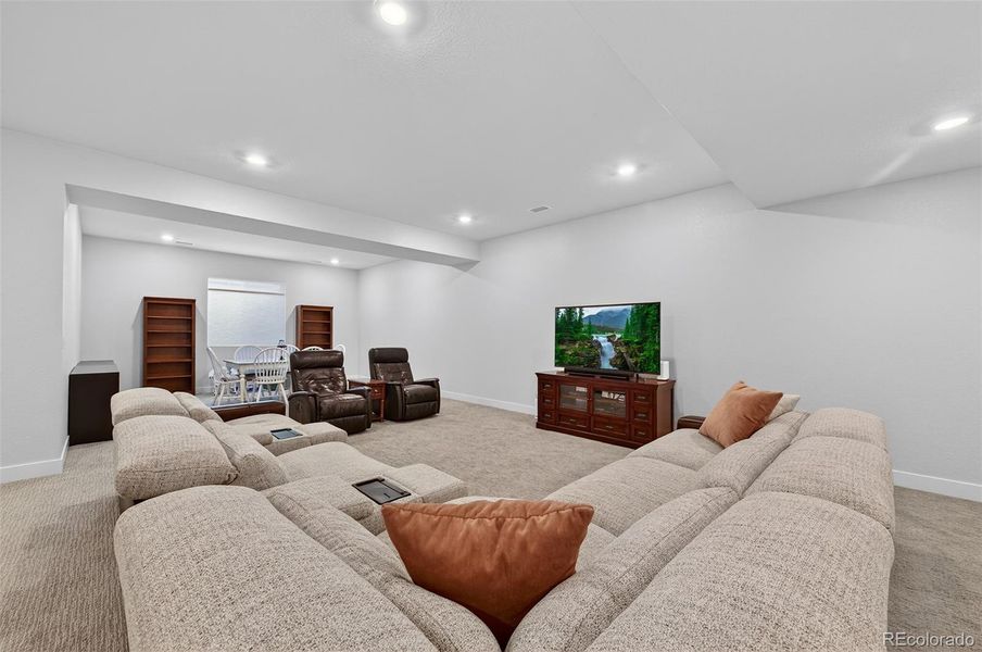 Basement Media Area (Angle 1) – Comfortable entertainment space with ample room for sectional seating and a large television setup, creating the perfect home theater experience.
