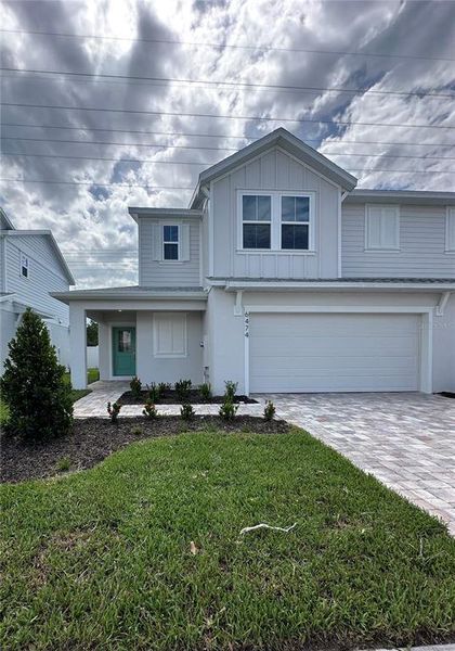 Front exterior of a new home in Cyrene at Harmony, St. Cloud, FL, highlighting curb appeal (Image 1).