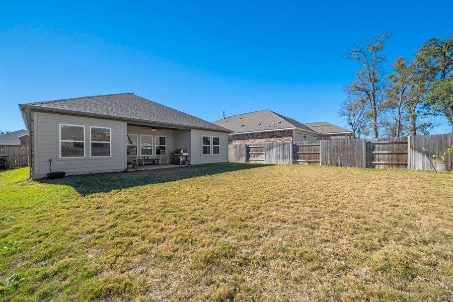 Rear view of house with a patio area, a ceiling fan, and a fenced backyard