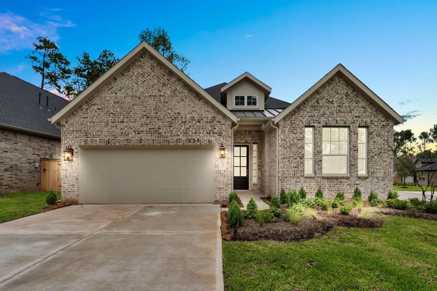 Front exterior of a new home in The Woodlands Hills, Willis, TX, highlighting curb appeal (Image 1).