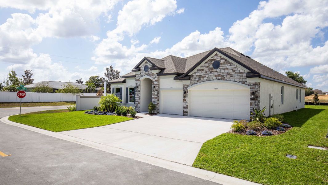 Front exterior of a new home in Malabar Springs, Palm Bay, FL, highlighting curb appeal (Image 27). Front exterior of a new home in Malabar Springs, Palm Bay, FL, highlighting curb appeal (Image 27).