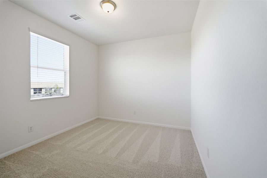 Empty room featuring light carpet and baseboards Empty room featuring light carpet and baseboards