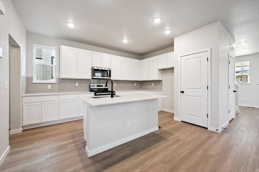A kitchen with white cabinets. A kitchen with white cabinets.