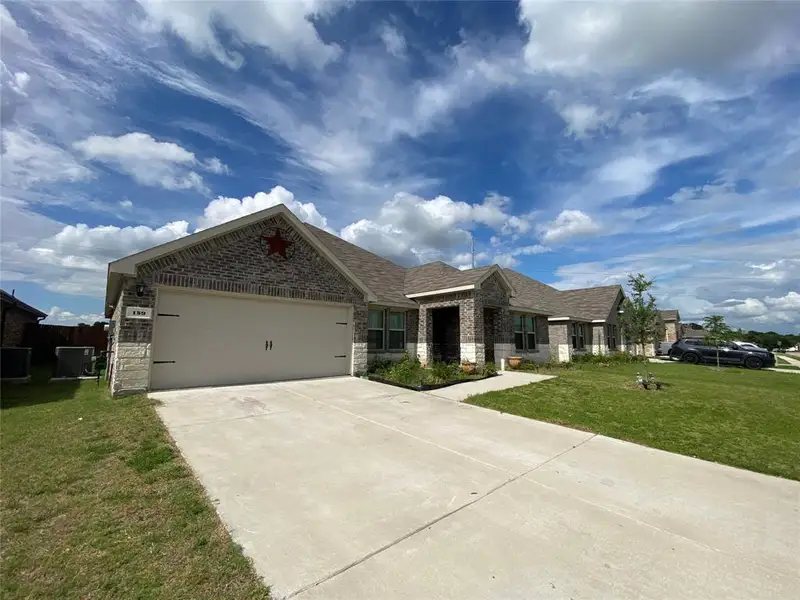 Front exterior of a new home in Stonehaven, Caddo Mills, TX, highlighting curb appeal (Image 9). Front exterior of a new home in Stonehaven, Caddo Mills, TX, highlighting curb appeal (Image 9).