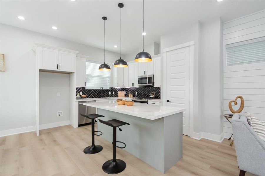 This contemporary kitchen features sleek quartz countertops that lend an air of sophistication and durability to the space.