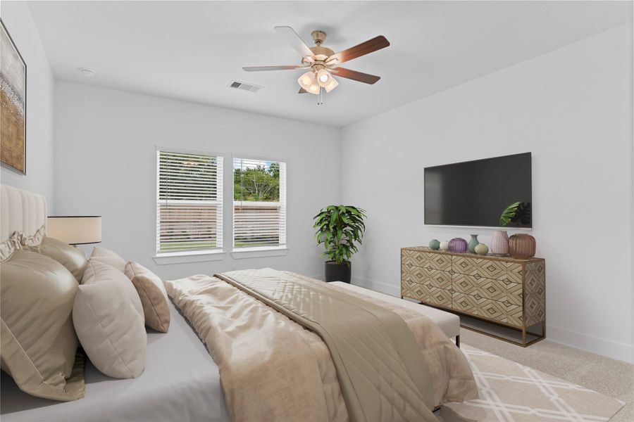 Inviting primary bedroom tucked away on the first floor, featuring plush carpet, large windows that bathe the room in natural light, and a ceiling fan for year-round comfort—your ideal space to unwind and recharge. *Virtually Staged* **Image Representative of Plan Only and May Vary as Built**.