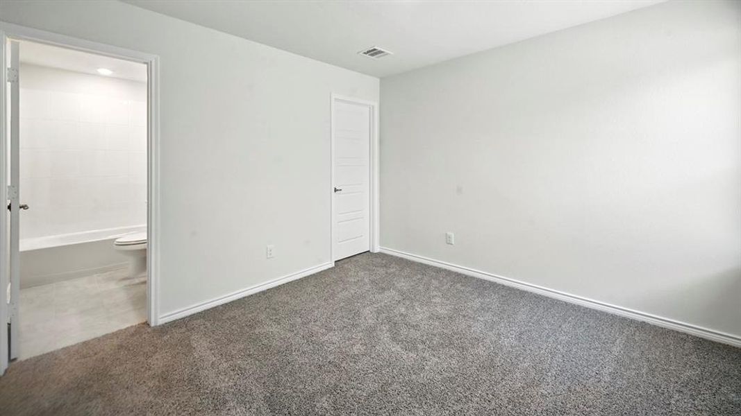 Unfurnished bedroom featuring carpet floors and connected bathroom