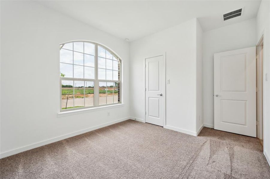 Unfurnished bedroom featuring light colored carpet and a closet