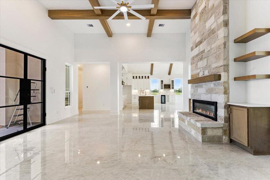 Another view of the living room showcasing the fireplace, built-in shelving, and spacious design. Another view of the living room showcasing the fireplace, built-in shelving, and spacious design.