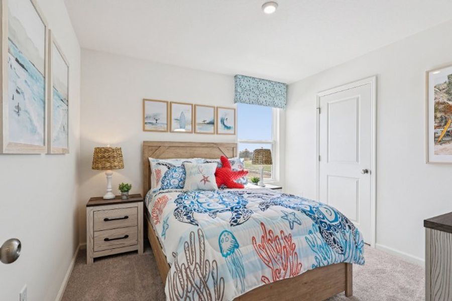 A bedroom with a bed and a lamp.