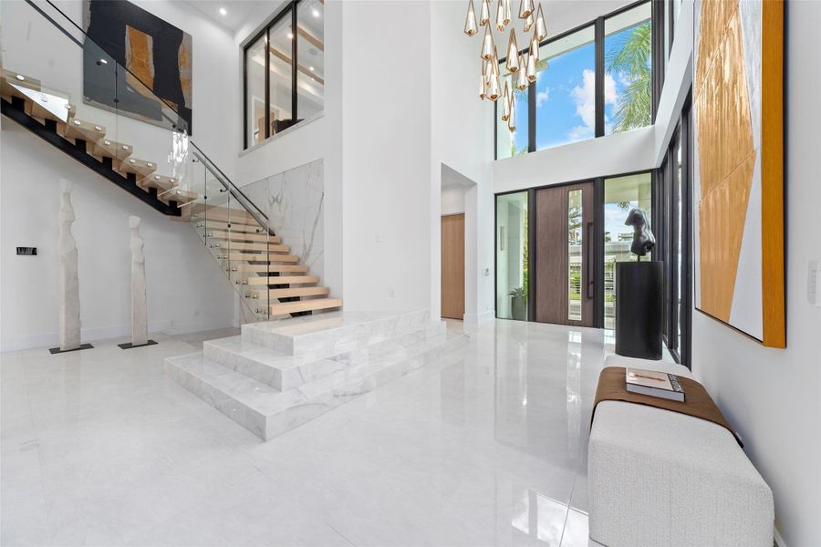 The grand entryway creates an immediate sense of space, light, and sophistication.