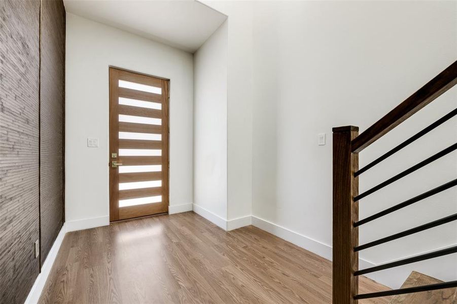 Entryway featuring light wood finished floors and stairs Entryway featuring light wood finished floors and stairs