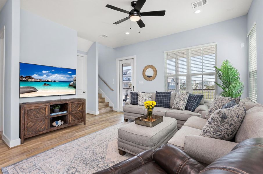 A cozy yet stylish gathering space, the living room features a modern ceiling fan, recessed lighting, and a smart TV, creating the perfect spot for movie nights or quiet afternoons.