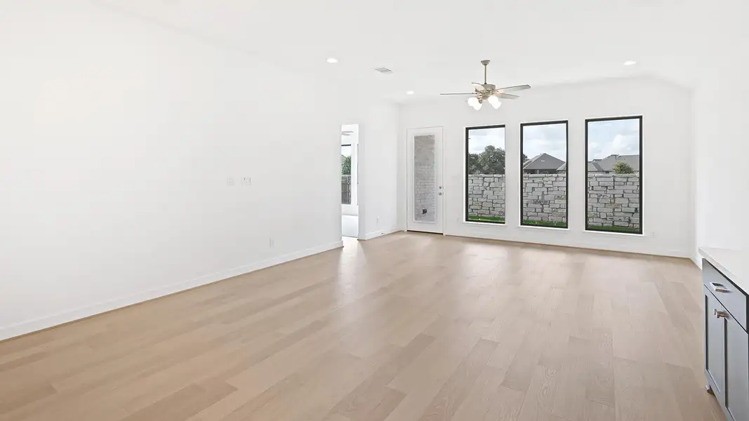 Unfurnished living room with light wood-style floors, recessed lighting, and a ceiling fan