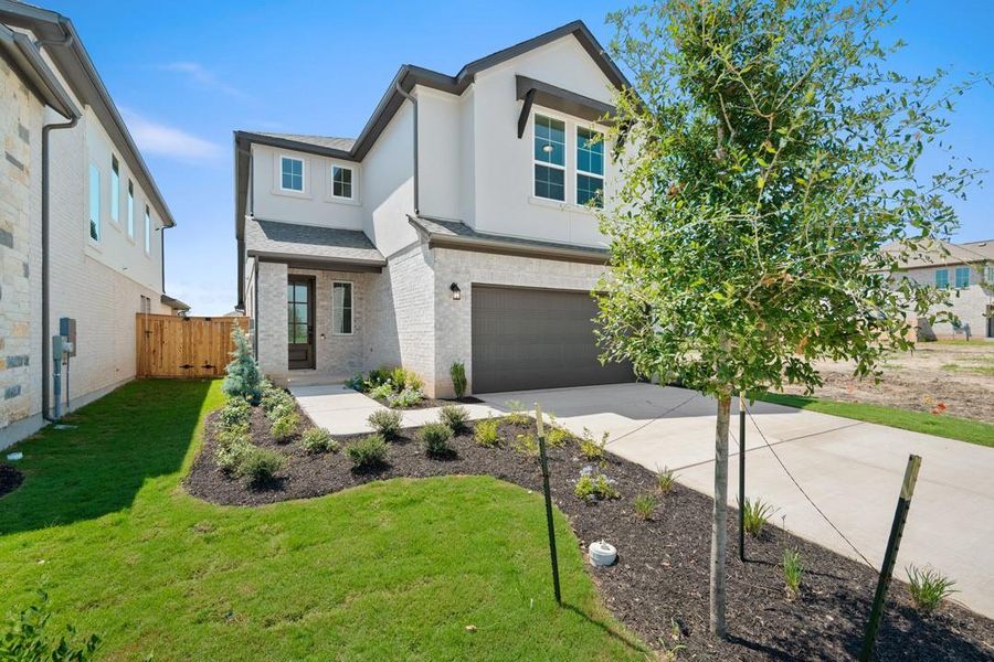 Front exterior of a new home in Flora, Hutto, TX, highlighting curb appeal (Image 22).