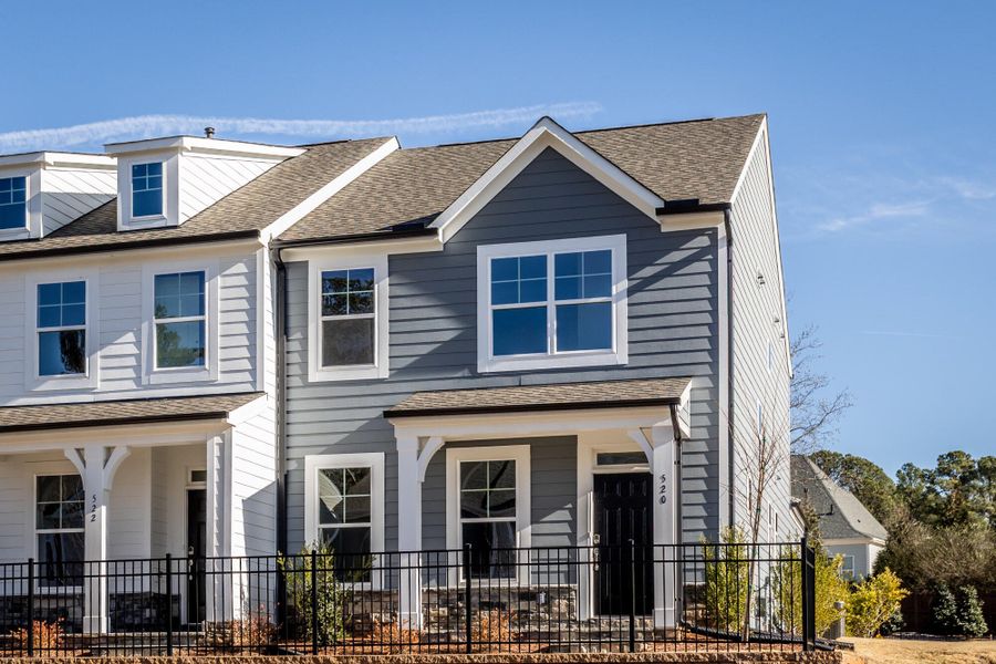 Front exterior of a new home in Enclave at Traditions Townhomes, Wake Forest, NC, highlighting curb appeal (Image 2). Front exterior of a new home in Enclave at Traditions Townhomes, Wake Forest, NC, highlighting curb appeal (Image 2).