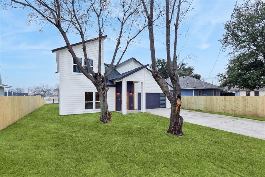 View of front of house featuring a garage and a front yard