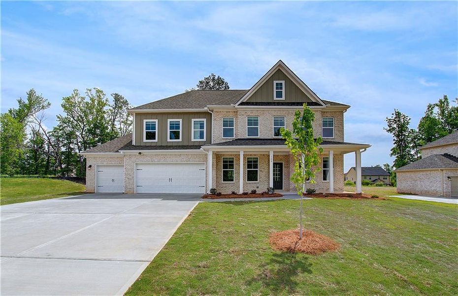 Front exterior of a new home in Cambria at Traditions, Hampton, GA, highlighting curb appeal (Image 16).